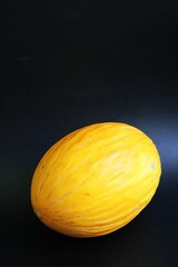 yellow melon, cantalupe melon, fruit on black background, juicy fruit