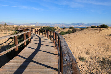 Fototapeta premium Wooden walkway in Arenales del Sol beach in the morning in Alicante, Spain