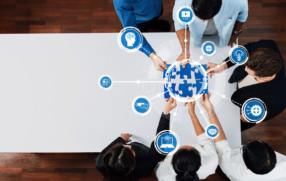 A diverse group of professionals collaborates to solve business challenges using AI and technology in a modern workspace, showcasing teamwork and innovative solutions. Amity