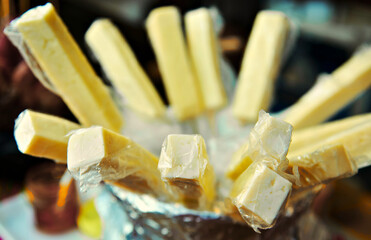 Grilled cheese on a skewer. Street food. Close up of a cheese served on a skewer 