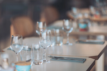 Elegant dining setup shines with sparkling glassware and delicate cutlery in a cozy restaurant during the evening hours, inviting guests for a memorable culinary experience