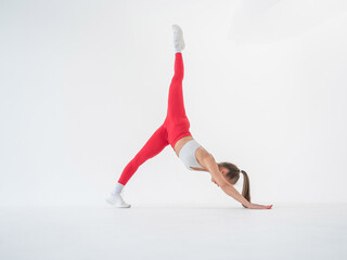 Caucasian woman doing sports exercises on white background. 