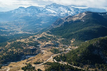 Naklejka premium Stunning mountain landscape showcasing a breathtaking view from above with rolling hills and snow-capped peaks, beautiful view of the mountain from above