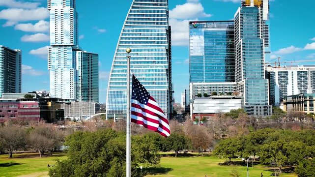 American flag waving in front of the austin skyline