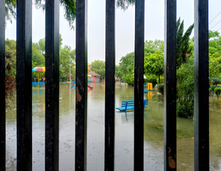 Flooded Playground with Colorful Equipment Submerged Under Rising Water