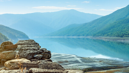 Foreground Focus. Scenic panoramic view from the medieval Ananuri fortress of the Zhinvali Water Reservoir and Caucasus mountains in Georgia, a popular travel destination on the Aragvi River