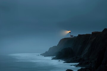 Scenic coastal lighthouse at night illuminated by misty ocean waves