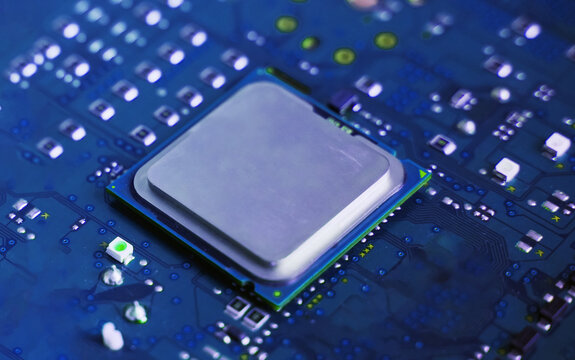 Close-up of a plain silver CPU chip mounted on a clean blue circuit board, symbolizing digital simplicity, core processing power, and electronic engineering.