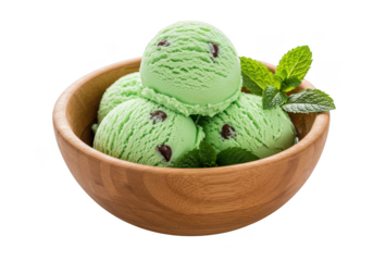 A wooden bowl filled with scoops of light green mint dessert and fresh green sprigs on a dark plane on transparent background