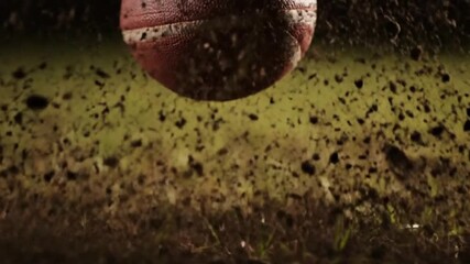 Slow-Motion Close-Up of Rugby Ball Impact Scattering Grass and Soil with Dramatic Lighting