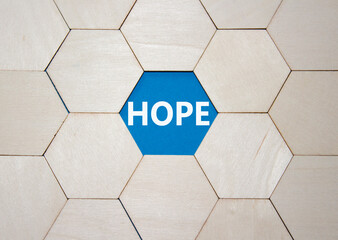 Hope symbol. Concept word Hope on wooden comb puzzle. Beautiful blue background. Business and Hope...