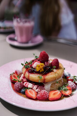 Midsummer Berry Pancakes with vanilla mascarpone, maple syrup and fruits. Pink plate, aesthetic desert, preppy style sweets	