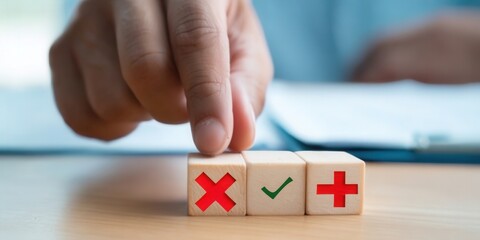 A hand selects between choices, symbolized by plus, check, and cross marks on wooden blocks.