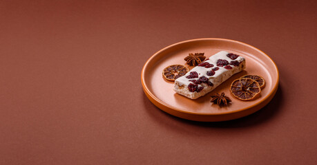 Nougat or white caramel with hazelnuts and pistachios and citrus pieces. White nougat with nuts