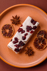 Nougat or white caramel with hazelnuts and pistachios and citrus pieces. White nougat with nuts