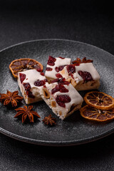 Nougat or white caramel with hazelnuts and pistachios and citrus pieces. White nougat with nuts