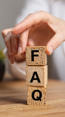 Frequently Asked Questions wooden blocks stacked by hand letters alphabet