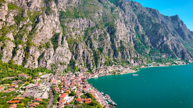 Charming Limone sul Garda sits on the edge of Lake Garda, surrounded by turquoise water and dramatic cliffs. Perfect for travel, real estate, and tourism-related commercial content