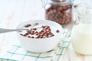 Making a healthy breakfast  chocolate corn balls and milk. Chocolate corn balls and milk, morning breakfast.