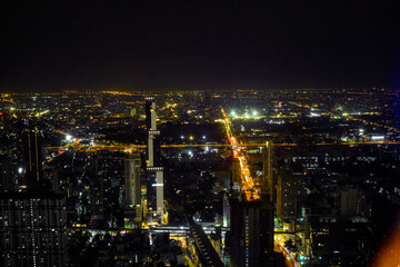 An enchanting aerial night view of a bustling Bangkok city, showcasing illuminated highways and...