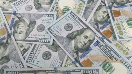 This is a closeup image showing stacks of U.S. hundred dollar bills from a top view