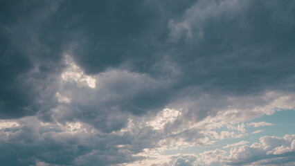 A Dramatic and Cloudy Sky with Sunlight Beautifully Peeking Through the Clouds above