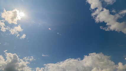 A Bright and Luminous Sky with Fluffy Clouds That Enhances Its Beauty and Appeal