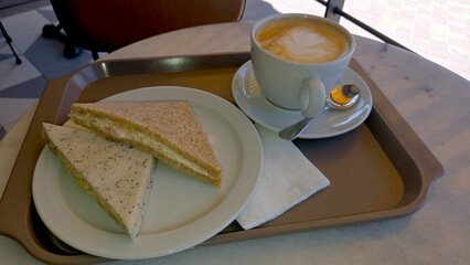 Hearty morning delight with sandwiches and coffee in a cozy cafe setting. Top view. Flat lay