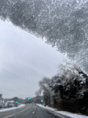 driving on a snow covered road - snowflakes on windshield 