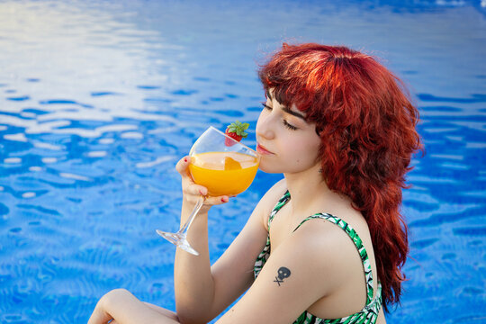 Relaxed young woman enjoying a day at the pool in summer - Powered by Adobe