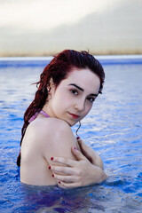 Relaxed young woman enjoying a day at the pool in summer