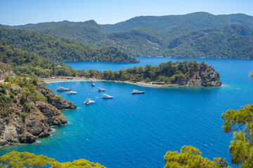 Fototapeta premium Boncuk Bay, Blue Lagoon and Oludeniz beach aerial panoramic view. Oludeniz is a beach resort in the Fethiye district of Mugla Province, Turkey.
