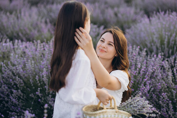 Mother and Daughter Harvesting Lavender in Blooming Field
