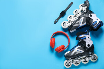 Flat lay composition with roller skates on blue background. Space for text