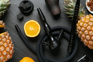 Hookah, coal and fresh fruits on black table, flat lay