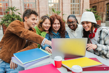A cheerful group of friends engaging with a laptop, excitedly discussing their projects and sharing...