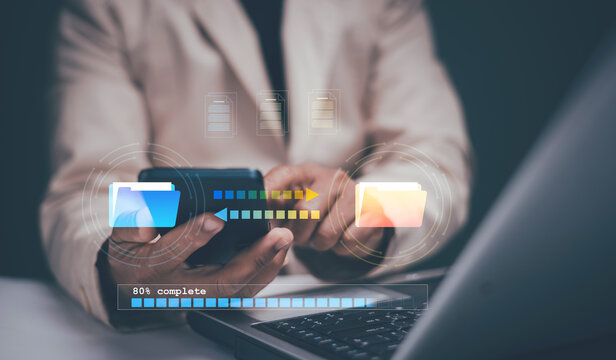 FTP (File Transfer Protocol) files receiver and backup data. Businessman using laptop and smartphone for online transfer document and file. Files recovery computer backup.