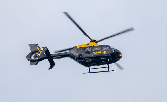 British Police helicopter on a search operation, operated by NPAS for Greater Manchester Police