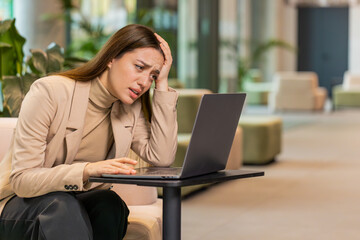 Caucasian young businesswoman girl using laptop notebook typing browsing, loses receive lottery...