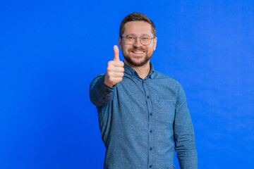 Like. Caucasian man raises thumbs up agrees with something or gives positive reply recommends...