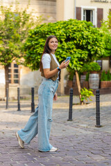 Tourist traveler young woman using smartphone typing text messages looking for search a way on map...