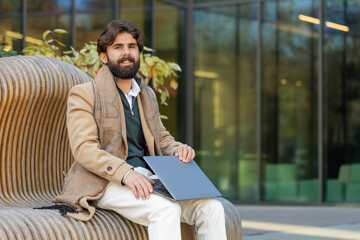 Indian business man freelancer closes laptop screen finishing working online distant job browsing...