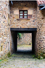 A low stone tunnel beneath a village house invites you deeper into the quiet streets of the Barcena Mayor.