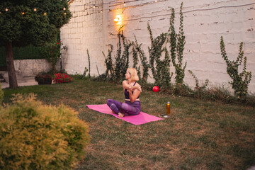 Mother rejuvenates with outdoor workout after childbirth in serene garden