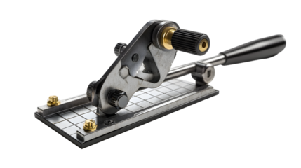 A metal tool with a handle and a roller on a grid patterned base against a black background studio shot