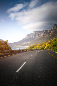 Scenic Coastal Road through Cape Town Suburbs with Mountains and Ocean View