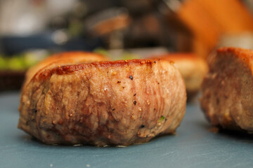 Close-Up of Seared Pork Filets Resting on a Wooden Cutting Board