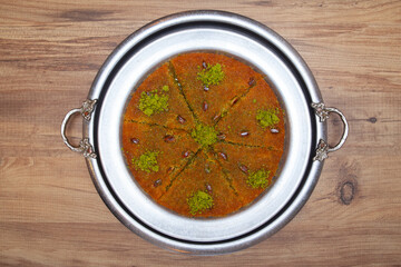 Traditional kunefe dessert with melted cheese and syrup – Turkish sweet pastry kunefe close-up