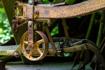 The metal wheel on the back of an old plow