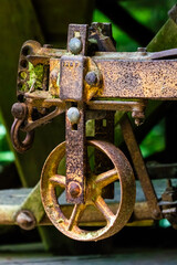 The metal wheel on the back of an old plow